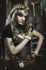 Fototapeta na wymiar Portrait of steampunk woman with gun