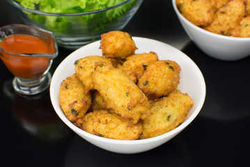 Fried rice balls in black background seen from above