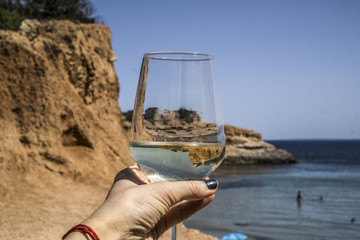 Glass with the cliff of the blue sea