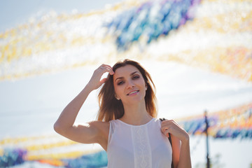 Portrait of happy young woman on a walk. Summer in the city