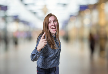 Fototapeta premium Pretty business woman angry over blur background