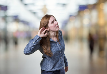 Pretty business woman listening something over blur background