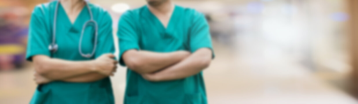 Blurred Banner Image Of Two Surgeons.