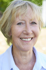 Outdoor Head And Shoulders Portrait Of Senior Woman