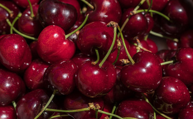 cherry detail macro of delicious fresh ripe red cherries with bright green stem, perfect food background Sweet cherry background