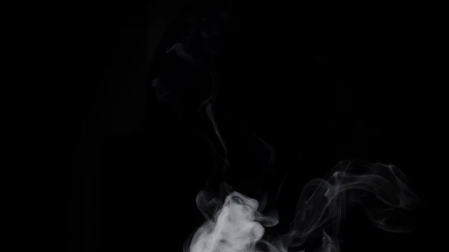 Smoke billowing over a black background.
