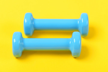 Workout and exercise equipment: two dumbbells in light blue color