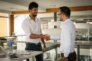 Fototapeta premium Two businessmen shaking hands in office. Successful business people.