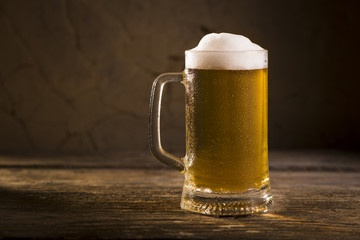 Glasses of light and dark beer on a pub background.