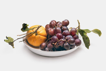 Ceramic plate with ripe fruit, isolated on white