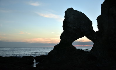 Sunrise at Australia rock in Narooma. The shape of Australia cut into the rock wall was accidental and was created when a ship was tied to the rock with large chains to prevent it from washing away.