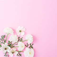 White flowers and leaves on pink background. Floral pattern. Flat lay, top view.