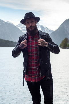 Photoshooting stylish bearded guys Hipster by Mountain Lake in Austria