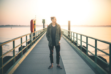 Young Man standing on a Pier