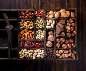 Nuts Mixed in a Wooden Vintage Box.Assortment, Walnuts,Pecan,Peanuts,Almonds,Hazelnuts,Macadamia,Cashews,Pistachios.Concept of Healthy Eating.Vegetarian.selective focus.