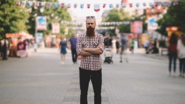 Zoom In Timelapse Of Young Bearded Man Standing Still At Sidewalk In Crowd Traffic With People Moving Fast