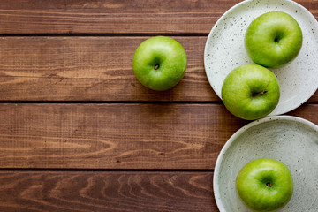 Healthy green food with apples on plates wooden background top view mock up