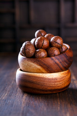 Macadamia Nut in Shell on Wooden Background.Vegetarian.Concept of Healthy Food.Copy space. selective focus.