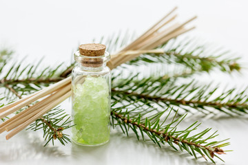Obraz na płótnie Canvas spa with organic spruce sea salt in glass bottles on white table background