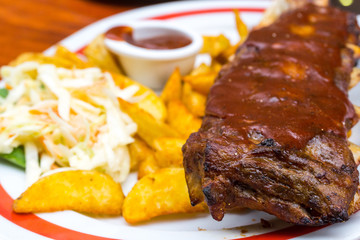 Grilled steak - Grilled meat ribs on the plate with hot sauce