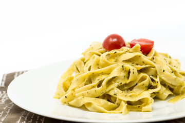 Pasta with pesto sauce and nuts on a the table