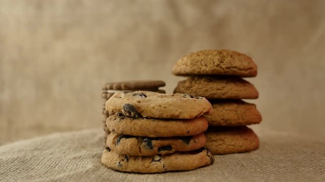 Chocolate homemade chip cookies or oatcake on sackcloth napkin background