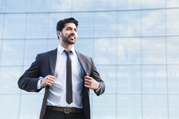 Successful businessman or worker standing in suit and holds jacket