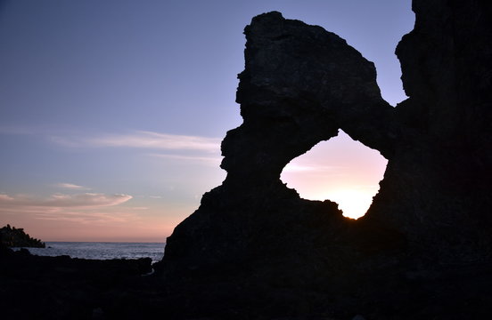 Sunrise at Australia rock in Narooma. The shape of Australia cut into the rock wall was accidental and was created when a ship was tied to the rock with large chains to prevent it from washing away.