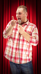 Studio portrait of a young showman with the microphone