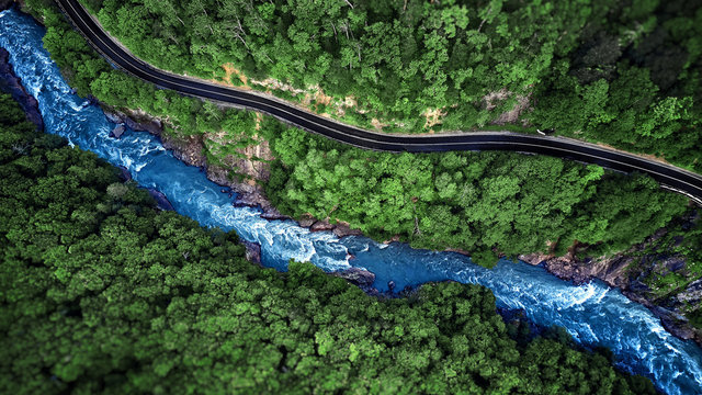 Aerial view of Mountain river and road. Mountain gorge