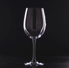 Empty wine glass on black background.