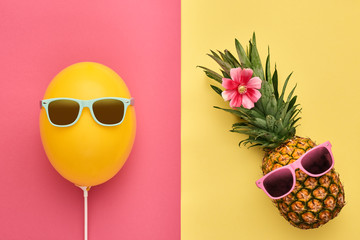 Fashion Pineapple and Yellow air Balloon. Bright Summer Color, Accessories. Tropical Hipster pineapple with Sunglasses. Creative Art concept. Minimal style. Summer party background. Fun