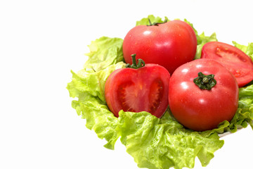 Fresh tomatoes and lettuce on a white background