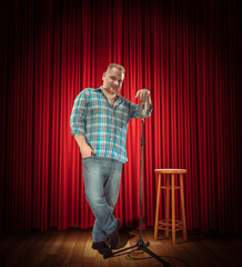 Studio portrait of a young showman with the microphone