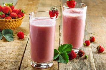 Delicious fruit milkshake made of fresh ripe strawberry and milk. Diet drink for healthy breakfast.