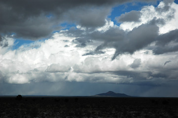 Obraz na płótnie Canvas storm cloud above land with far mountain