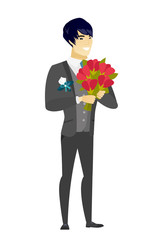 Asian groom holding a bouquet of flowers