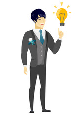 Groom pointing at business idea light bulb.