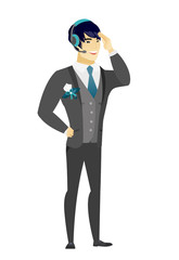 Young asian groom in headset.