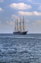 Naklejka na ściany i meble Sailing ship in the blue sea