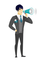 Fototapeta premium Asian groom talking into loudspeaker.