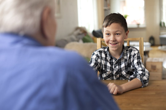 Young boy, 10 years old, talking to grandfather