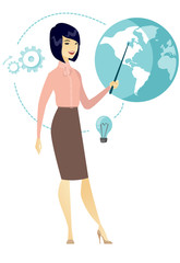 Asian business woman pointing at a globe
