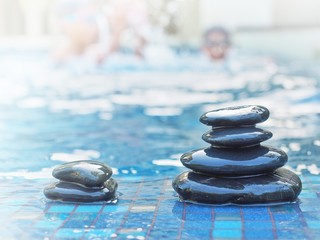 stacked stone on floor swimming pool background