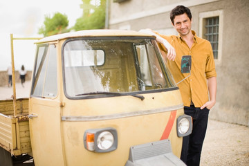 Man leaning on a piaggio Ape