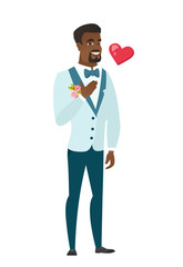 African-american groom holding hand on his chest.