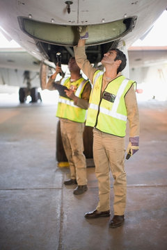 Aircraft workers checking airplane