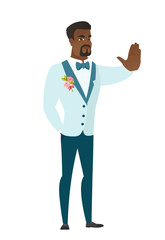 African-american groom showing stop hand gesture.