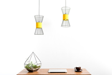 Laptop and mug with hot drink on table