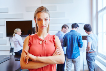 Obraz premium Junge Geschäftsfrau mit verschränkten Armen